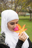 Beutiful Girl With Hijab Posing with rose in nature