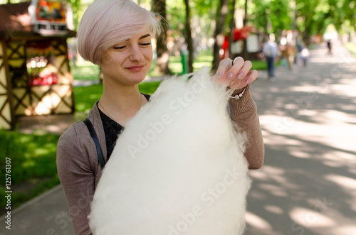 Young girl with cotton candy in the park