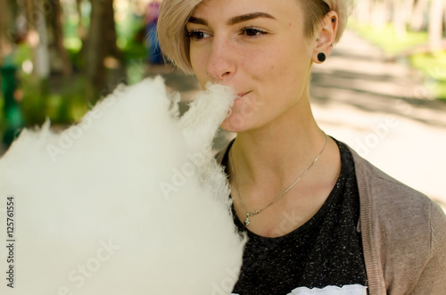 Young girl with cotton candy in the park