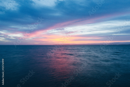 Sunrise over calm water