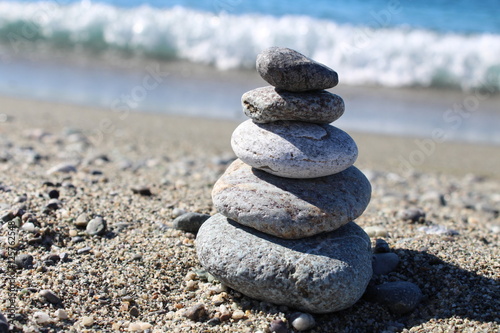 Balance Zen Stones on Sand Sea