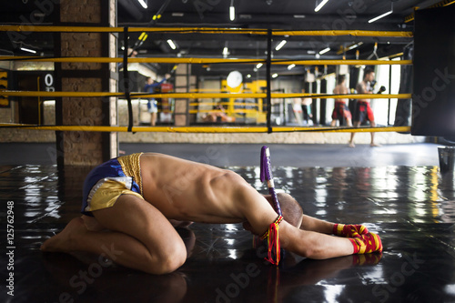 Fighter Muay Thai bowed in the ring photo