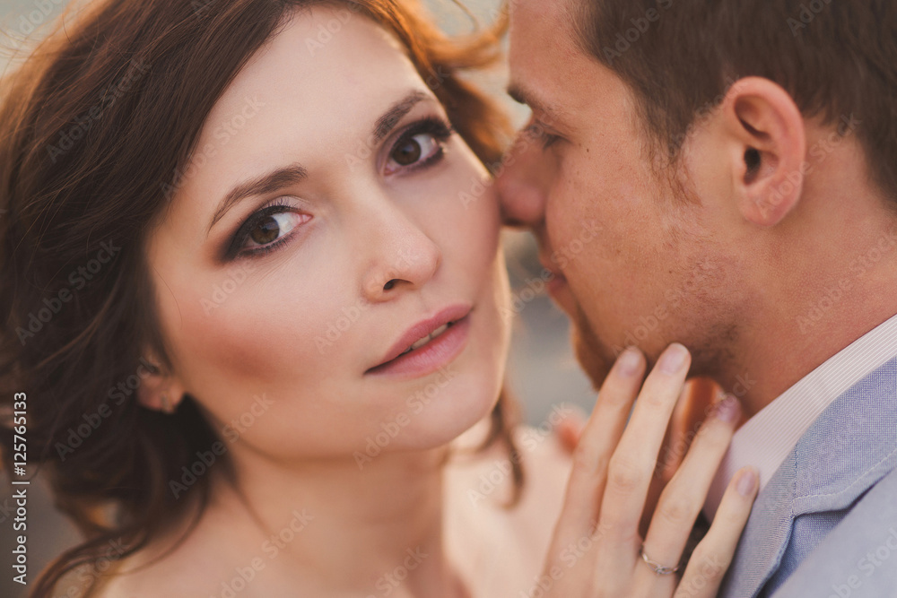 Romantic and stylish caucasian couple hugging at sunrise. Love, relationships, romance, happiness concept. Romantic and stylish caucasian couple hugging at sunrise. Love, relationships, romance, happiness concept.