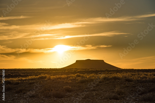 Golden sunset behind a butte