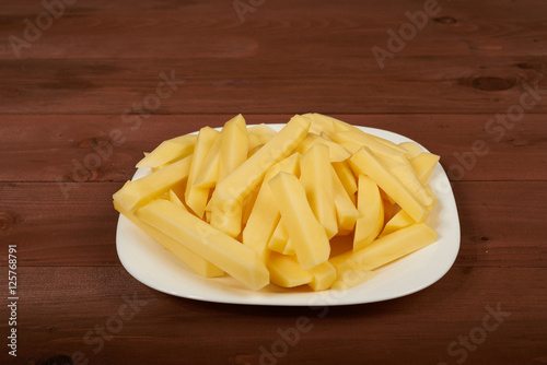 slicing raw potato on the plate