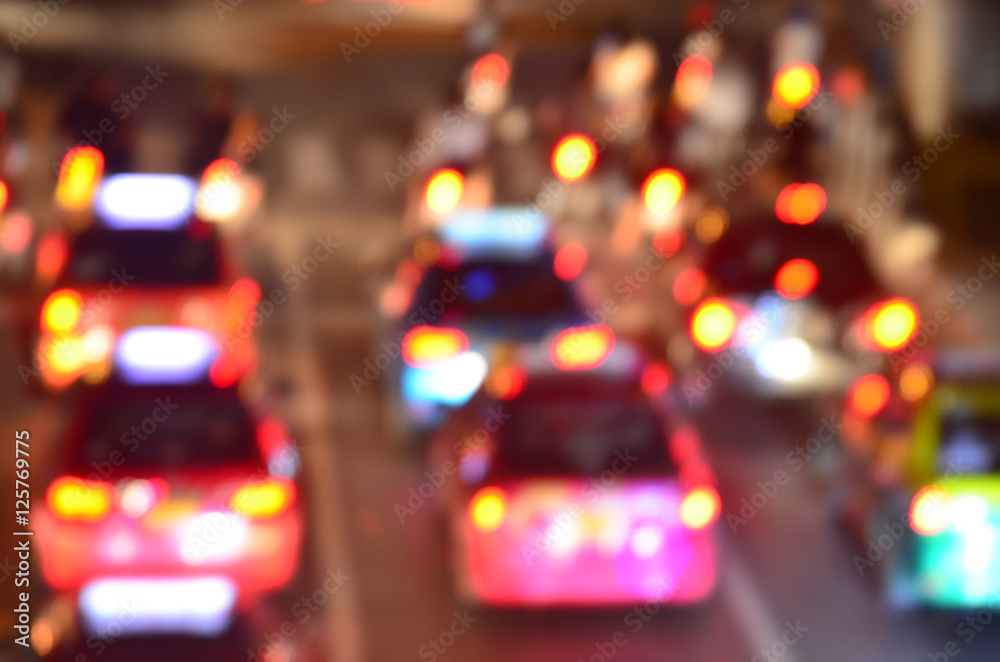 Blurred photo of car on the road with bokeh background of city s Blurred photo of car on the road with bokeh background of city s