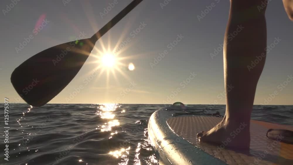 CLOSE UP: Detail of paddling stand up paddleboard through sparkling ocean water