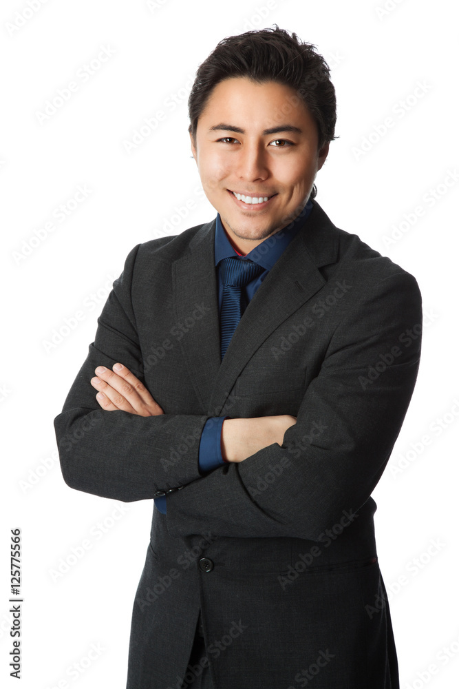 A handsome businessman wearing a grey suit with a blue shirt and tie standing against a white background. A handsome businessman wearing a grey suit with a blue shirt and tie standing against a white background.