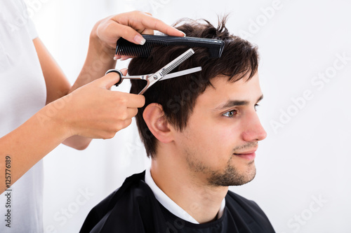 Man Getting Haircut From Hairdresser