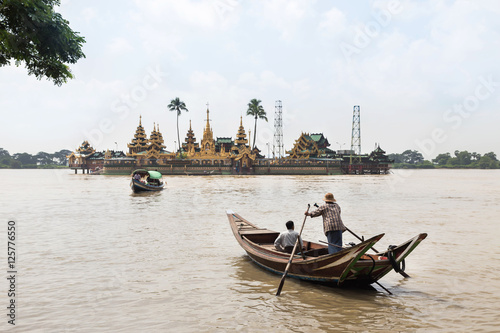 people cross yangon river by boat for pray at Ye Le Paya pagoda the floating pagoda on small island in Yangon Myanmar (Burma)