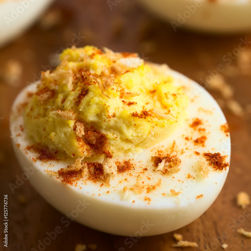Deviled egg with roasted panko breadcrumbs and paprika powder, photographed with natural light (Selective Focus, Focus on the front of the egg yolk)