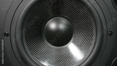 A black vibrating working subwoofer