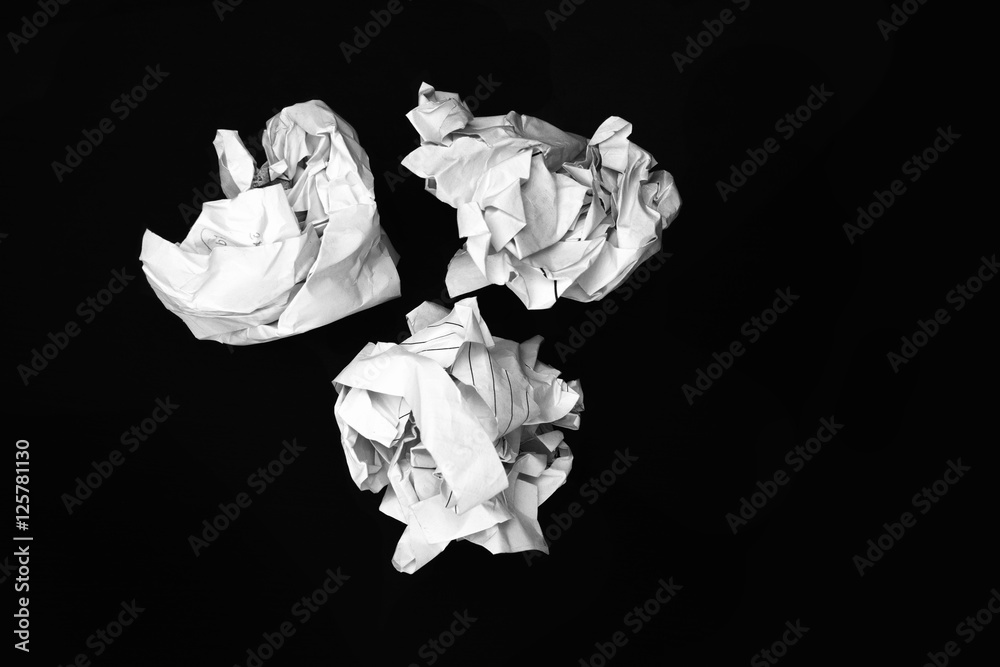 Crumpled paper ball on black background
Crumpled paper ball on black background