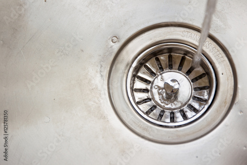 Dirty stainless steel sink close up.