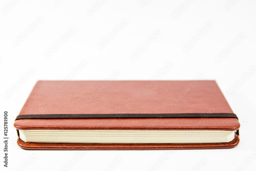 Small brown notebook isolated in white background. Small brown notebook isolated in white background.