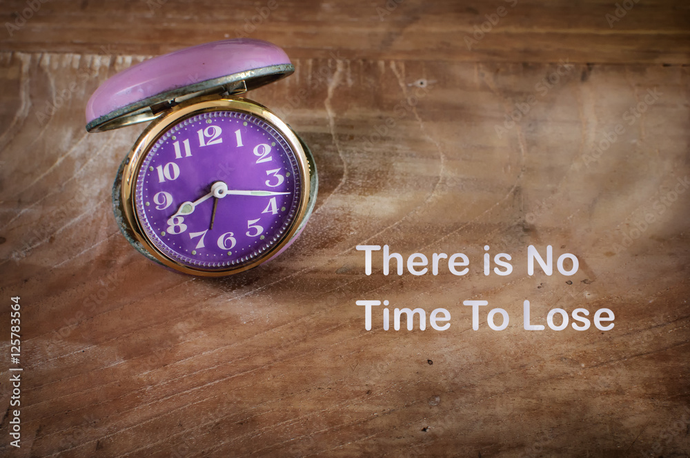 No time to lose on sticky note with alarm clock, time management concept No time to lose on sticky note with alarm clock, time management concept