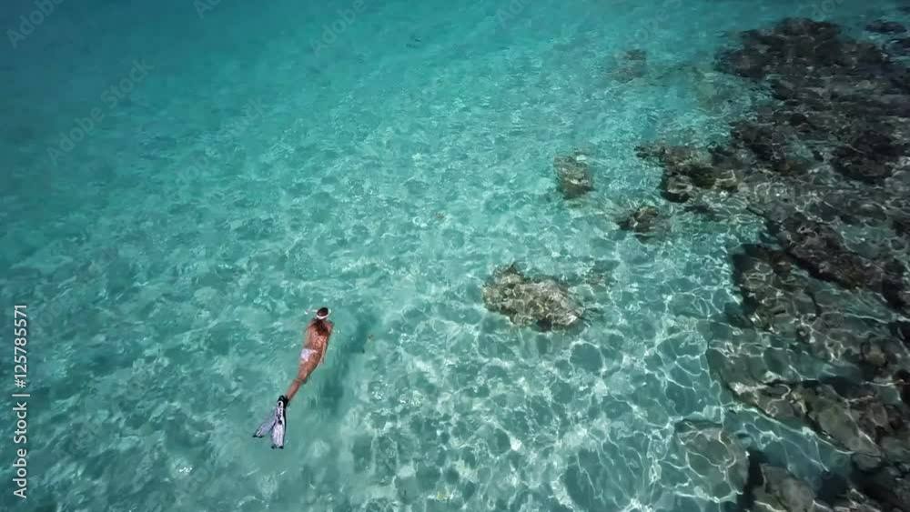 Aerial view of a woman snorkeling above tropical reef, St John, United States Virgin Islands Aerial view of a woman snorkeling above tropical reef, St John, United States Virgin Islands