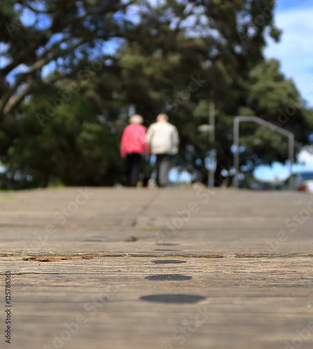 old couple strolling on walkway