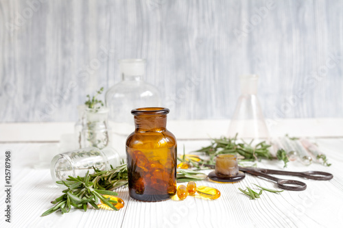 Fototapeta Naklejka Na Ścianę i Meble -  concept - natural medicine herbs in bottles on wooden background