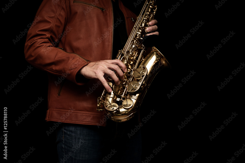 Fototapeta premium Jazz saxophone musician in the leather jacket, closeup.