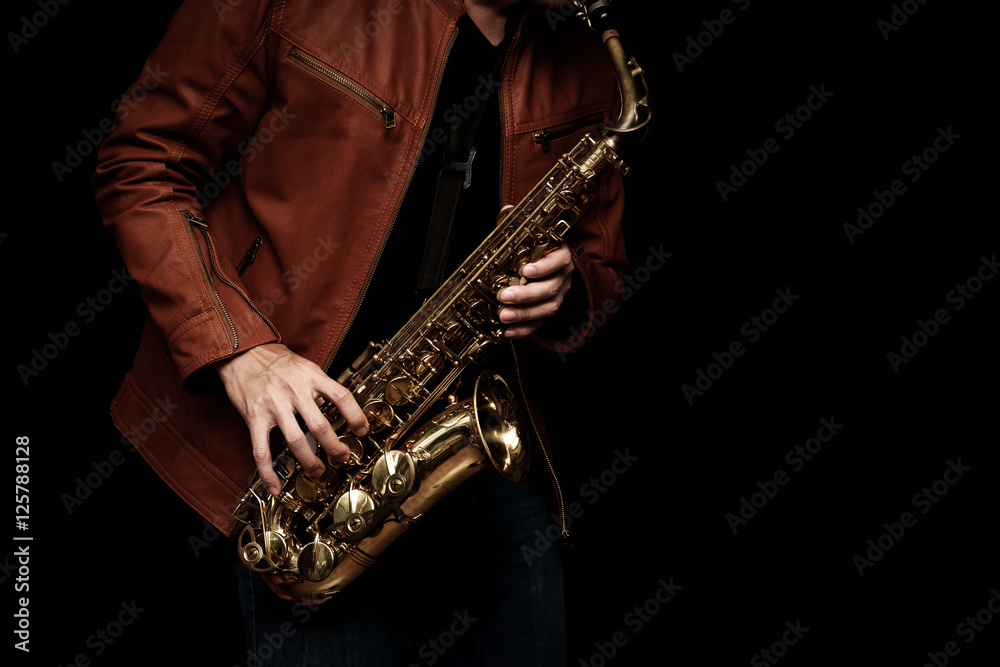 Obraz premium Jazz saxophone musician in the leather jacket, closeup.