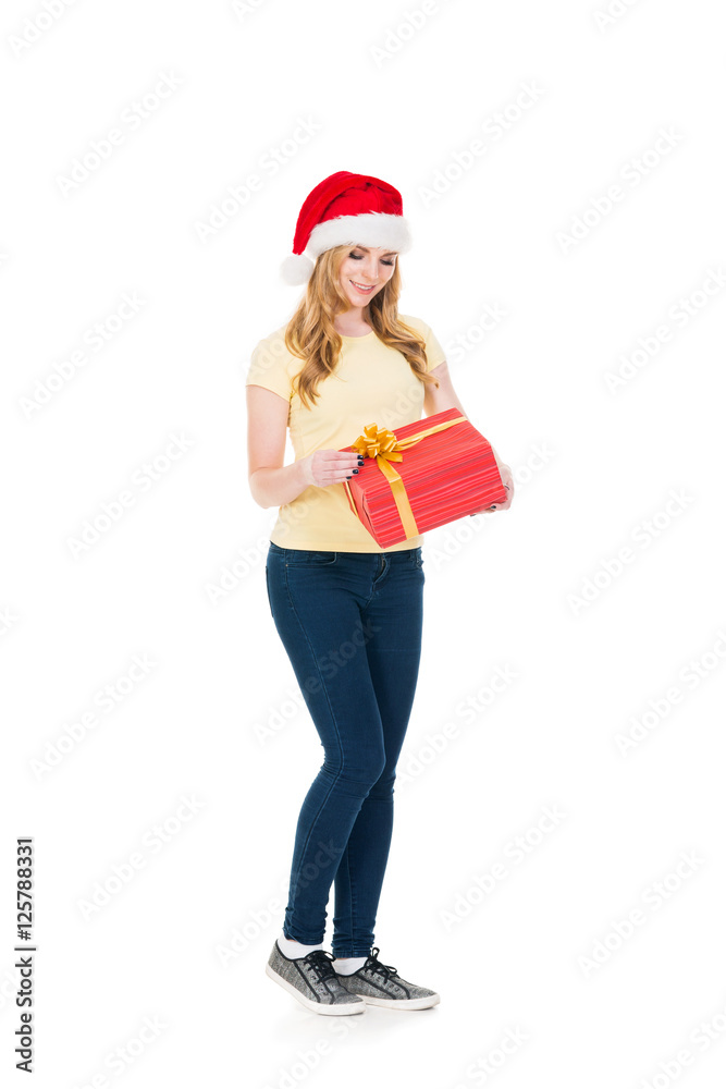 Happy teenage girl posing in a Christmas hat on white Happy teenage girl posing in a Christmas hat on white