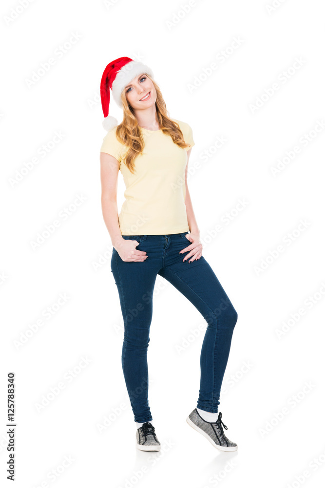 Happy teenage girl posing in a Christmas hat on white Happy teenage girl posing in a Christmas hat on white