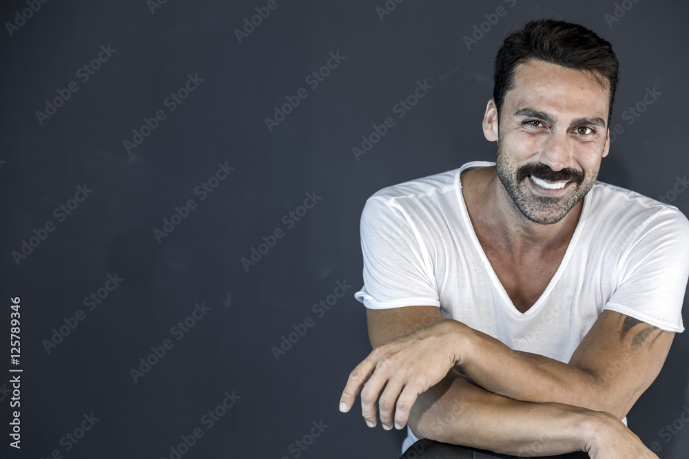 Young and attractive man with mustache studio portrait