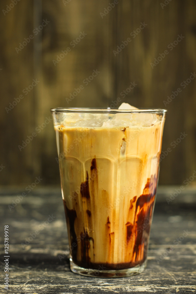 Iced coffee with chocolate on the wood table.
Iced coffee with chocolate on the wood table.