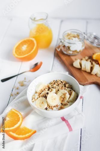 healthy breakfast bowl of yogurt with granola and banana