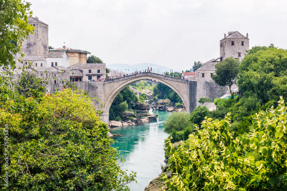 Beautiful view on Mostar city with old bridge, mosque and ancient buildings on Neretva river in Bosnia and Herzegovina