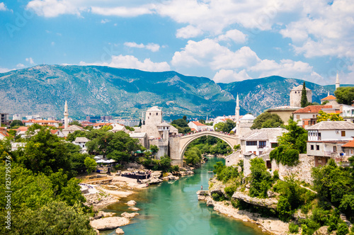 Beautiful view on Mostar city with old bridge, mosque and ancient buildings on Neretva river in Bosnia and Herzegovina