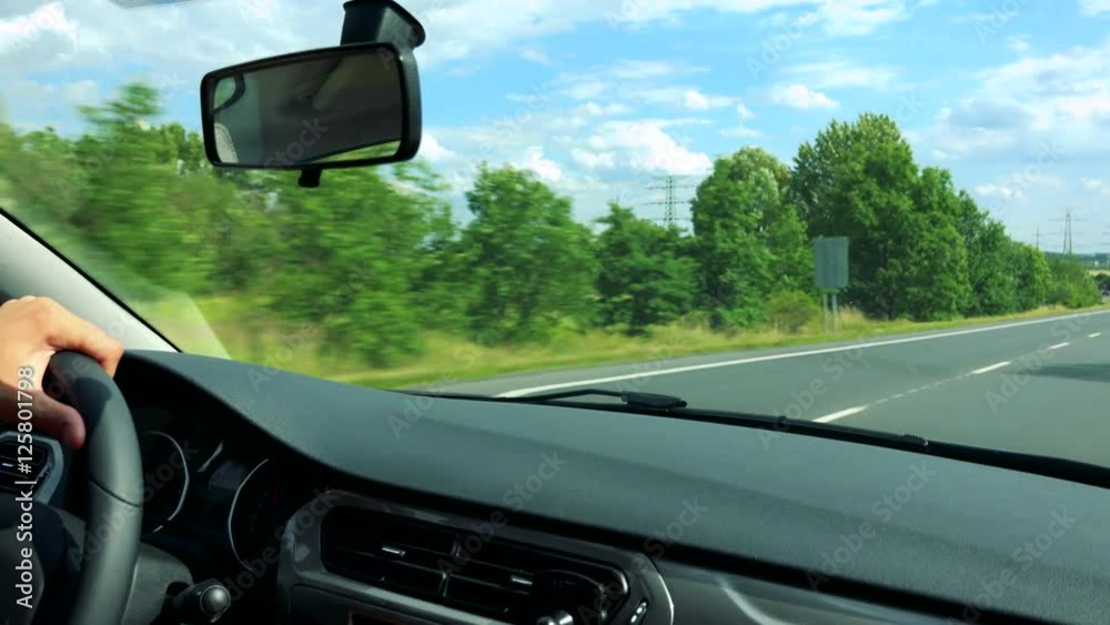 man drives a car in the city - road with passing cars and nature man drives a car in the city - road with passing cars and nature