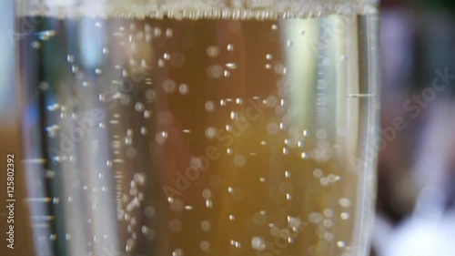 One glass of champagne waiting to be served by guests