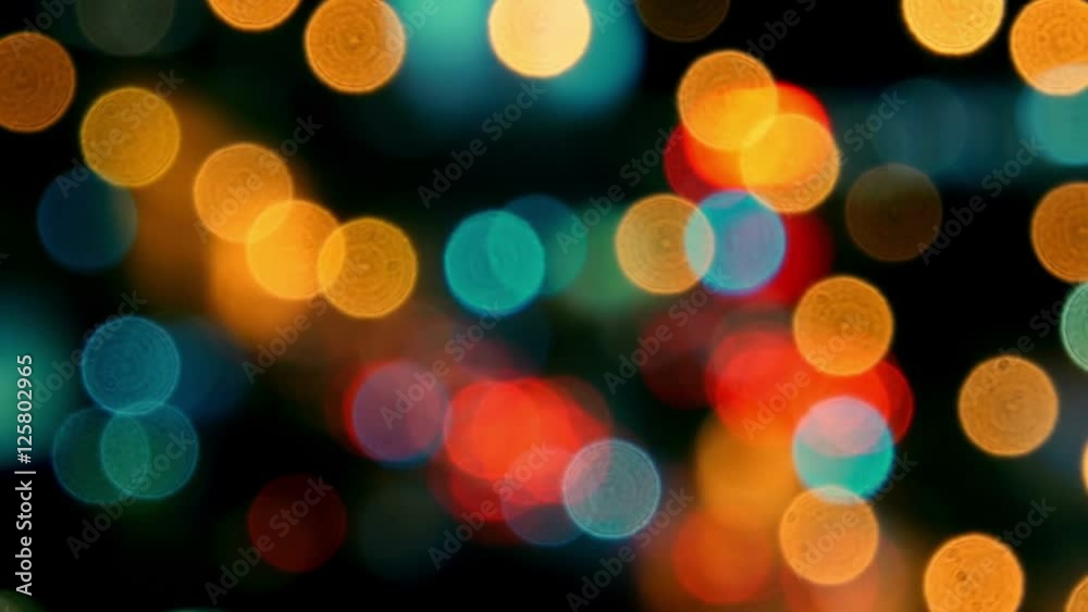 Pan across city blur background. Moving bokeh circles of night traffic. 
