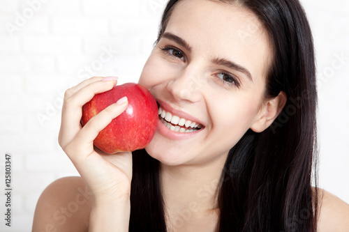 Woman with apple close-up face. Beautiful women exists to clean skin on the face. Concept of natural food. Asian woman.