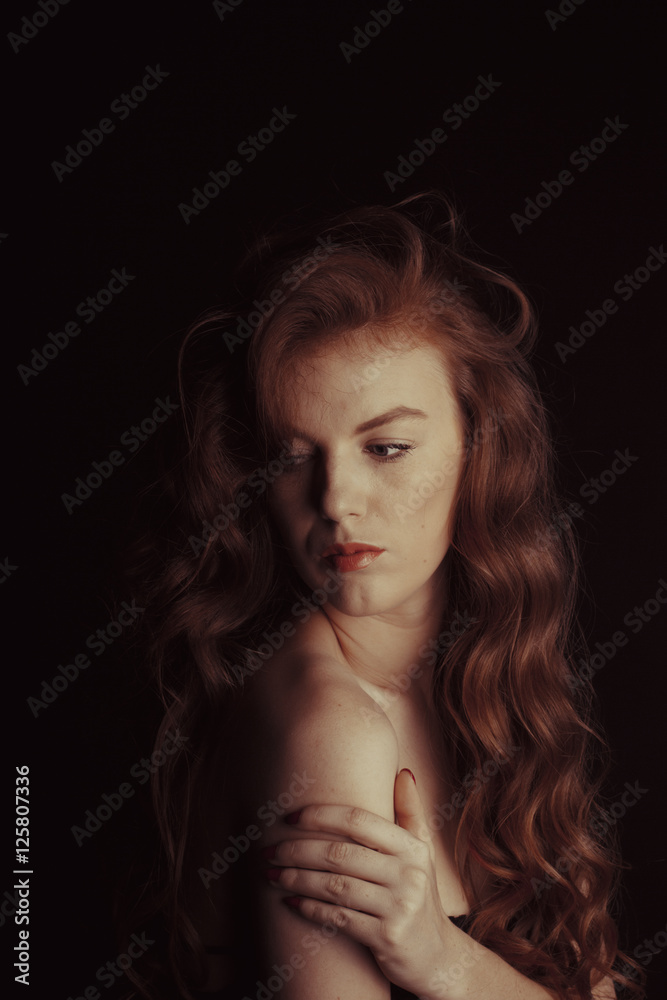 Sensual woman with long hair in the shadows