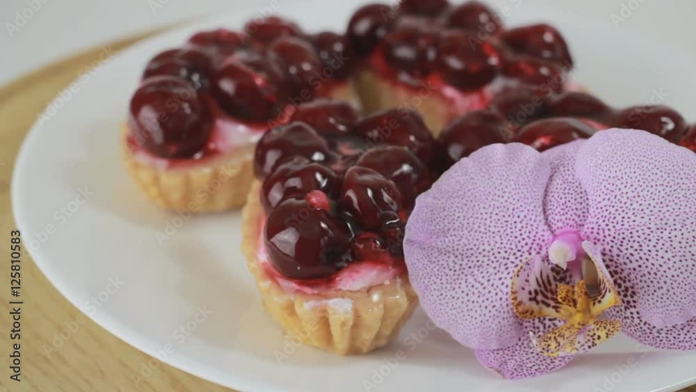 Cherry dessert rotating on a white plate Cherry dessert rotating on a white plate