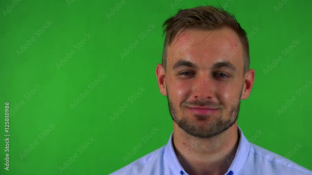 young handsome business man smiles to camera - green screen - studio - closeup young handsome business man smiles to camera - green screen - studio - closeup