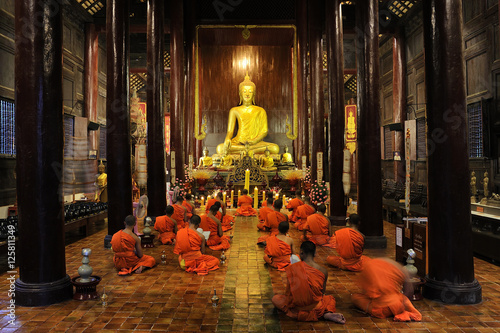 Buddhist monks pray and meditate every day evening at Wat Phan Tao in CHIANG MAI THAILAND.