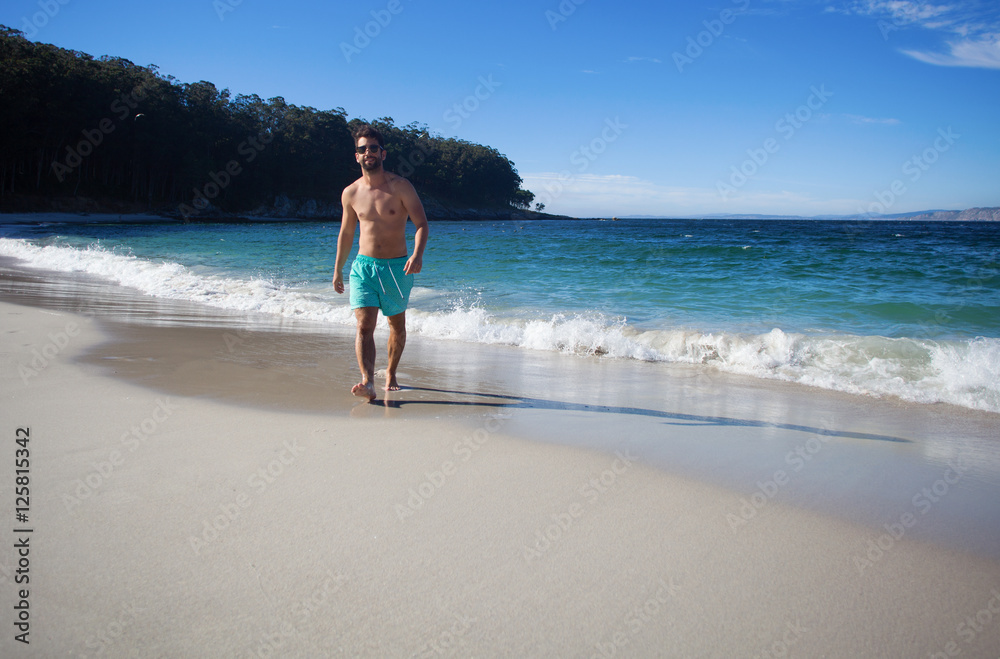 young man walking in the beach young man walking in the beach