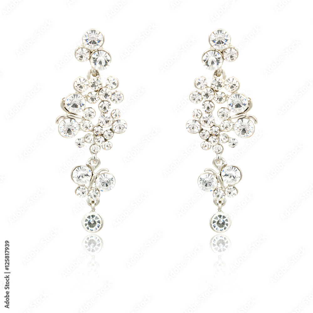 Pair of silver diamond earrings isolated on white Pair of silver diamond earrings isolated on white