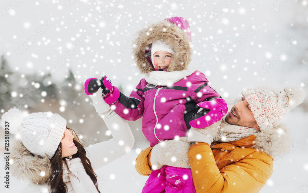 Fototapeta premium happy family with child in winter clothes outdoors