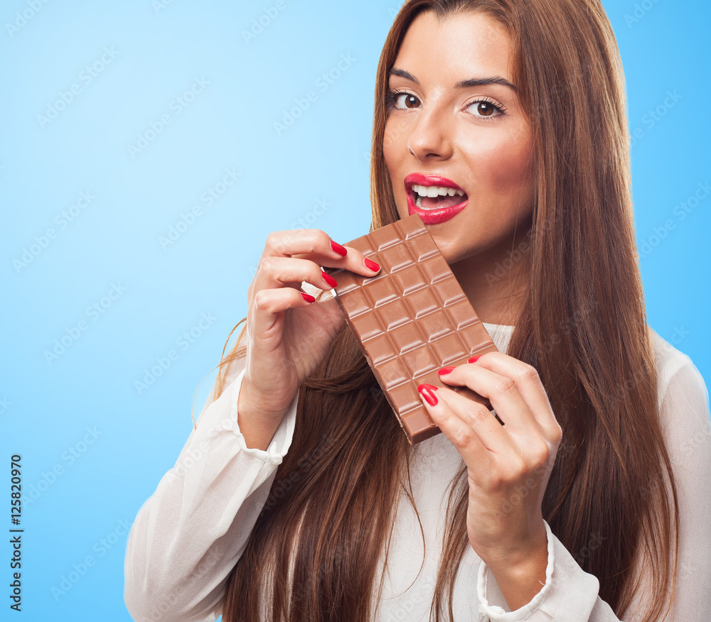 portrait of a pretty girl biting a chocolate bar portrait of a pretty girl biting a chocolate bar