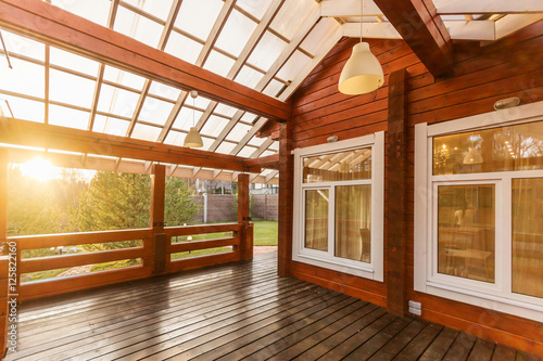 Konstfotografi Large Porch of the log cabin at sunset