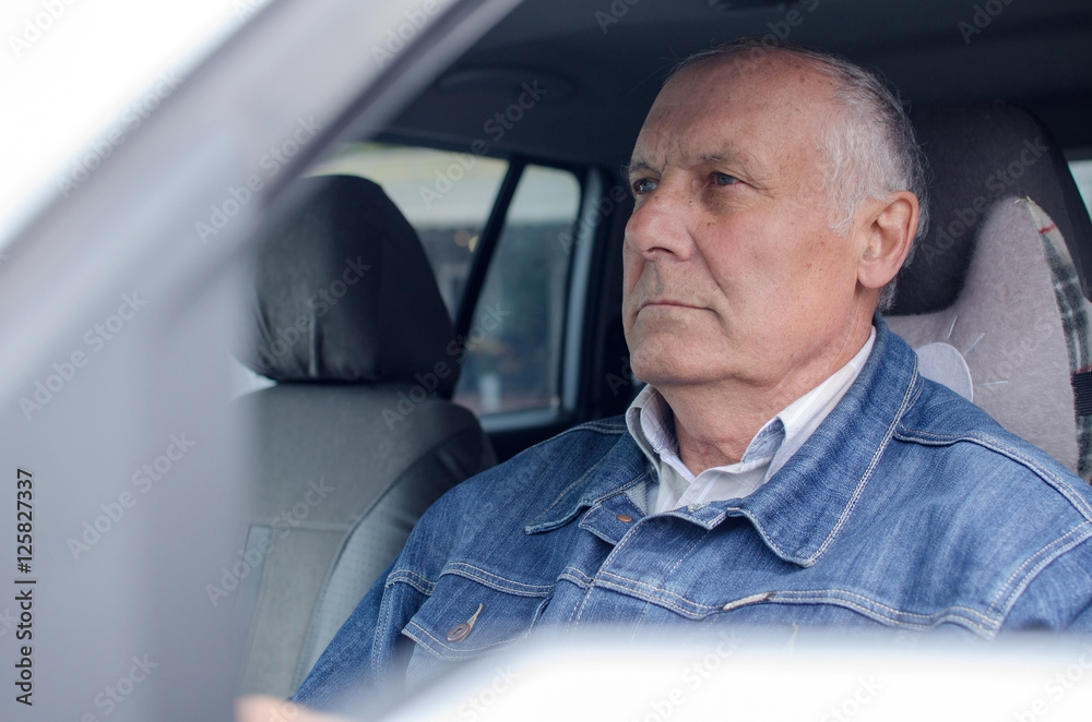 Aged man sitting in the car Aged man sitting in the car