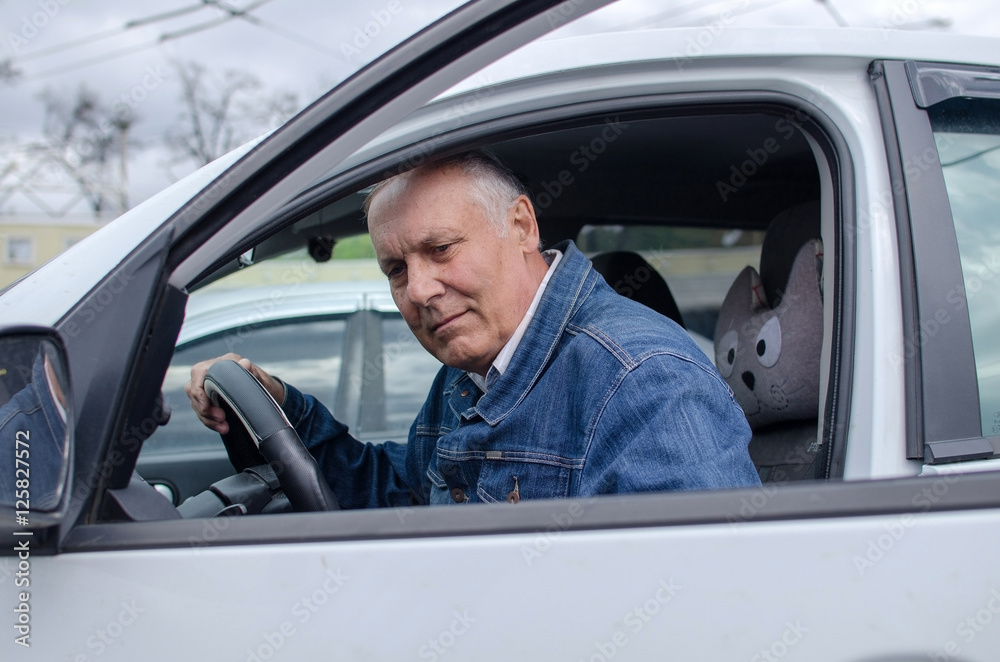 Aged man sitting in the car Aged man sitting in the car