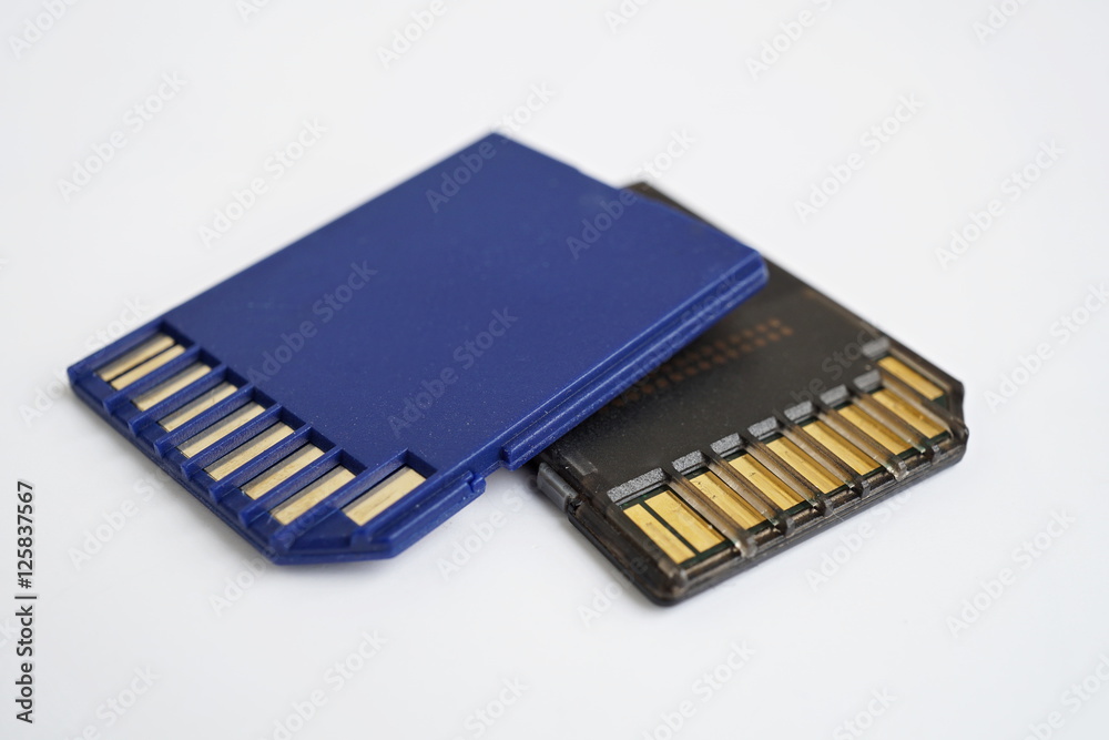 Two isolated plastic blue and black compact memory card (SD card - Secure Digital card) used in cameras, computers and video cameras in a blue color with metal connectors in the golden color Two isolated plastic blue and black compact memory card (SD card - Secure Digital card) used in cameras, computers and video cameras in a blue color with metal connectors in the golden color