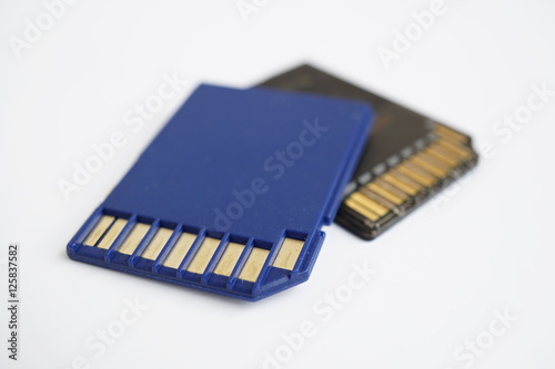 Two isolated plastic blue and black compact memory card (SD card - Secure Digital card) used in cameras, computers and video cameras in a blue color with metal connectors in the golden color