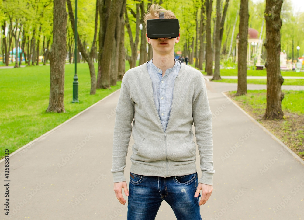 Young man using virtual glasses